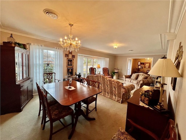 dining area featuring a notable chandelier, light colored carpet, crown molding, and visible vents