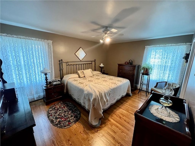 bedroom with wood finished floors and a ceiling fan