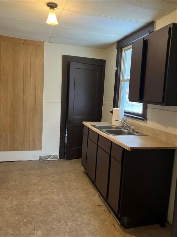 kitchen featuring a sink, visible vents, and light countertops