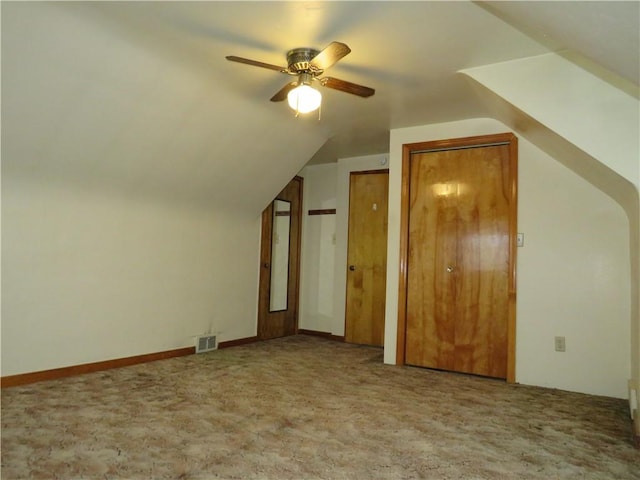 additional living space featuring vaulted ceiling, carpet, and visible vents