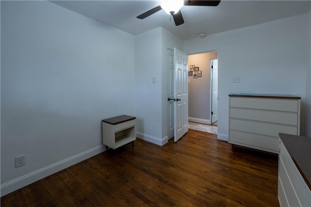 unfurnished bedroom featuring a ceiling fan, baseboards, and dark wood-style flooring