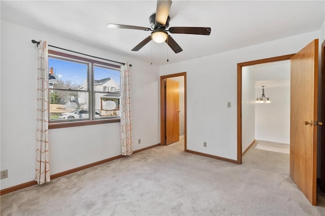 unfurnished bedroom featuring carpet flooring, ceiling fan, and baseboards