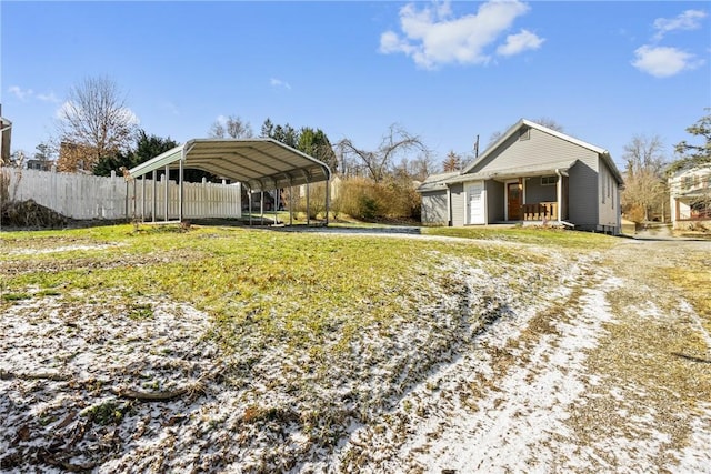 view of yard featuring a detached carport and fence