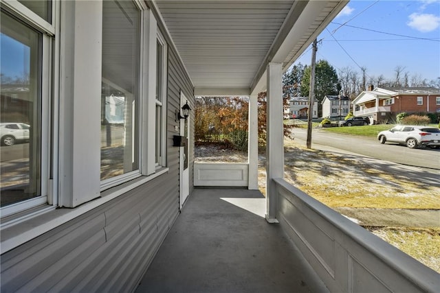 view of patio / terrace with a residential view and covered porch