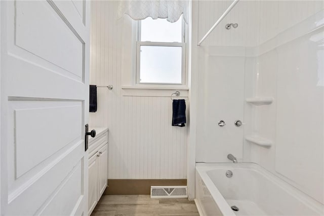 full bathroom with bathtub / shower combination, wood finished floors, and visible vents