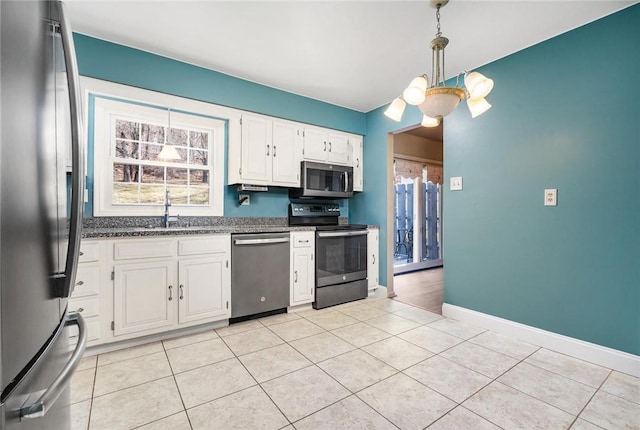 kitchen featuring white cabinetry, light tile patterned floors, a sink, and stainless steel appliances