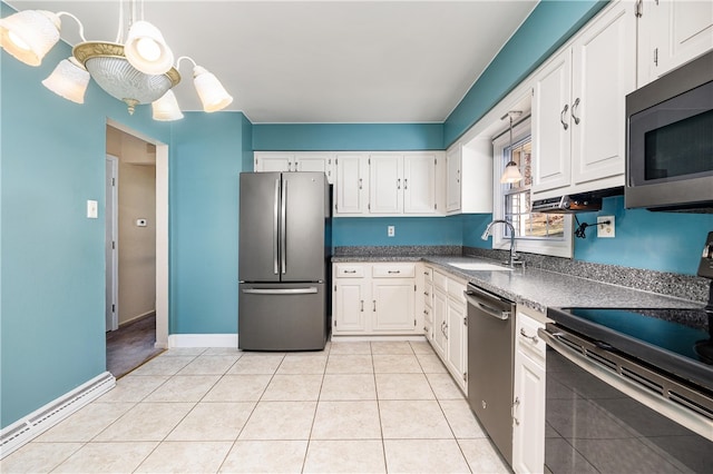 kitchen with white cabinetry, light tile patterned floors, appliances with stainless steel finishes, and a sink