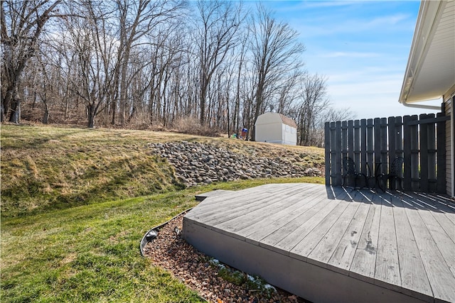 deck with a yard and fence