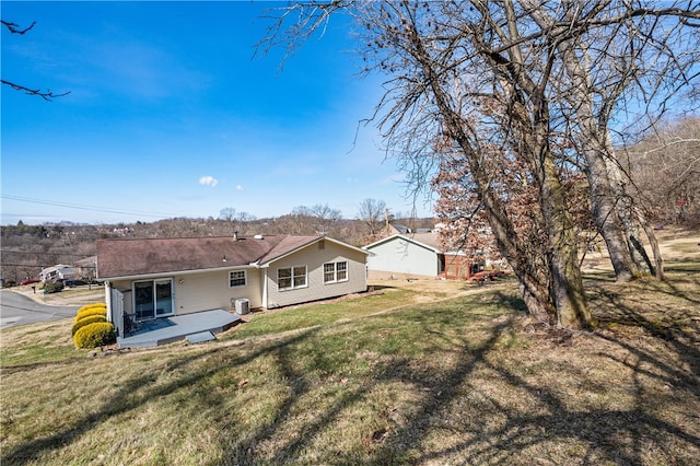 back of house featuring a patio area, central AC unit, and a lawn