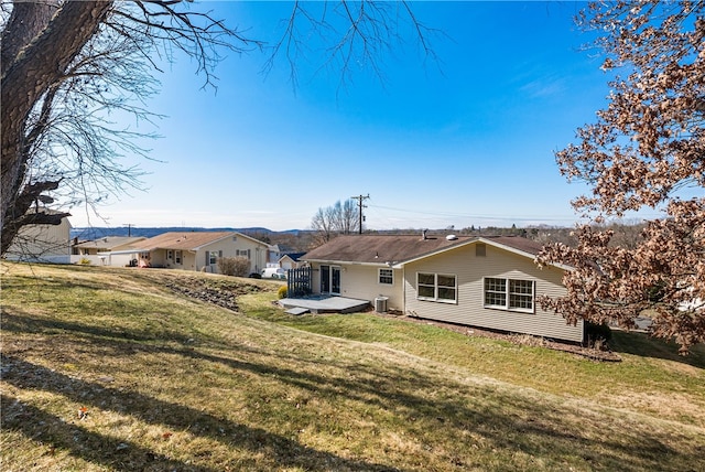 rear view of property with a yard, central AC, and a wooden deck