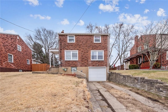 view of front of home with fence, concrete driveway, a garage, brick siding, and a chimney