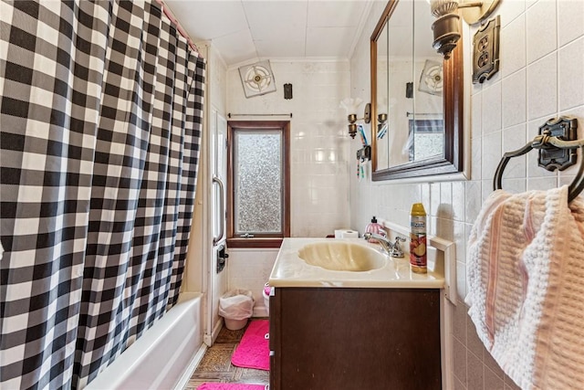 full bath featuring shower / tub combo with curtain, crown molding, tile walls, and vanity