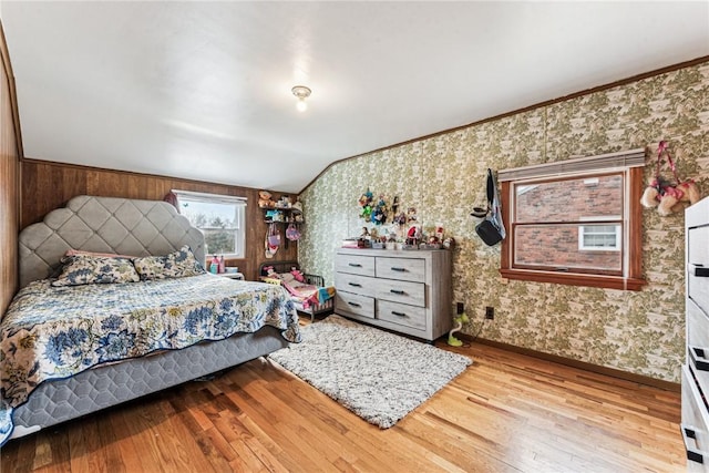 bedroom with vaulted ceiling and hardwood / wood-style flooring