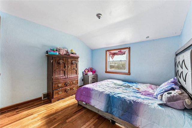 bedroom featuring vaulted ceiling and wood finished floors