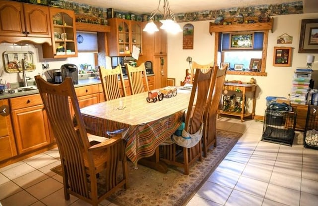 dining space featuring light tile patterned flooring and an inviting chandelier