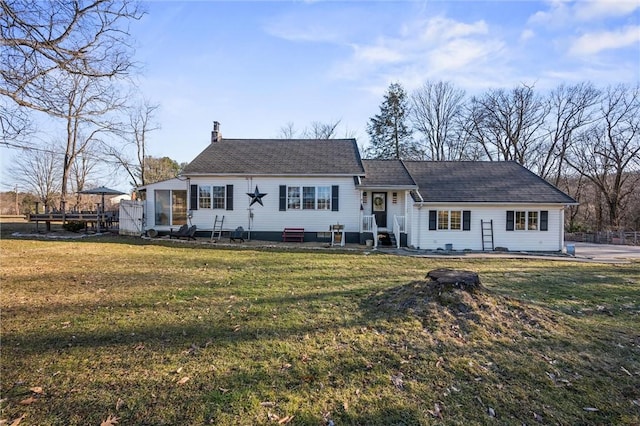 view of front of property featuring a chimney and a front lawn