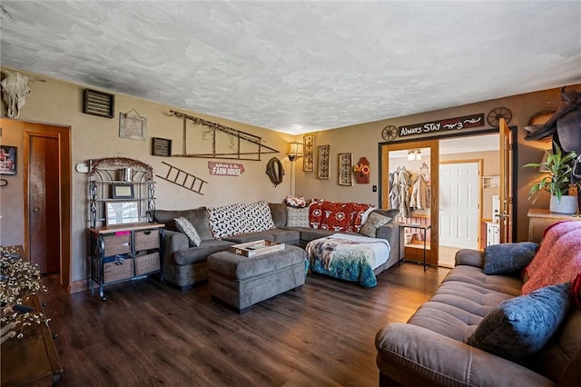 living room with a textured ceiling and wood finished floors