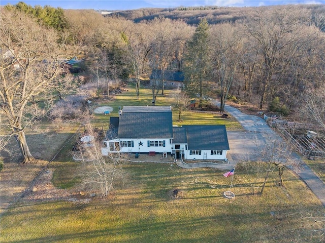 drone / aerial view featuring a wooded view