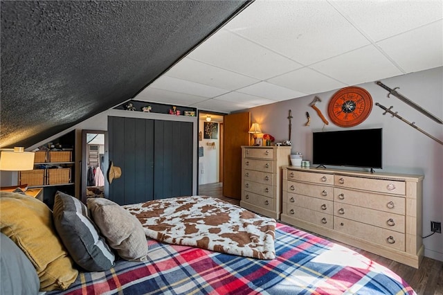 bedroom featuring lofted ceiling and wood finished floors