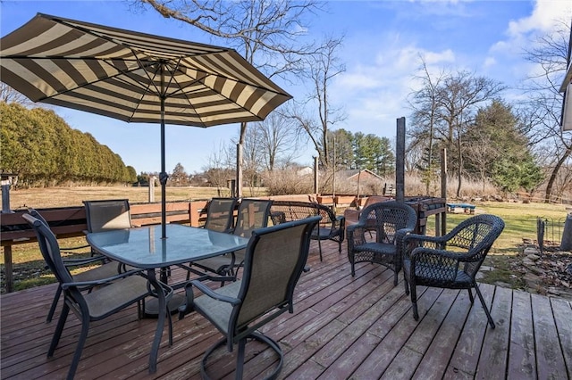 wooden terrace featuring outdoor dining area