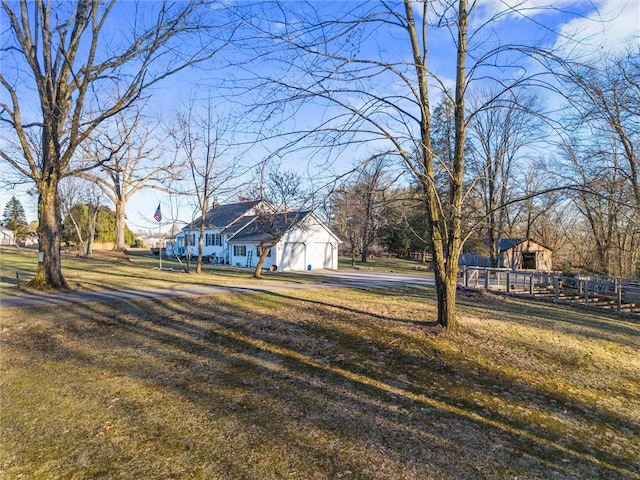 view of yard featuring fence and a garage