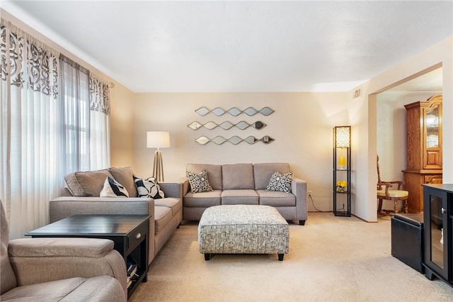 living room featuring visible vents and light colored carpet