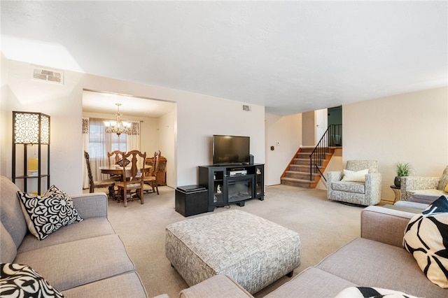 living room featuring stairs, a notable chandelier, visible vents, and light carpet