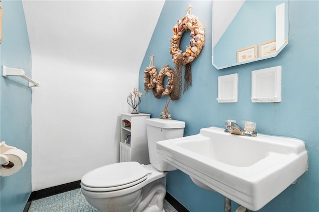 half bath with toilet and a sink