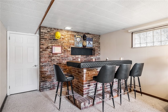 bar featuring a bar and carpet