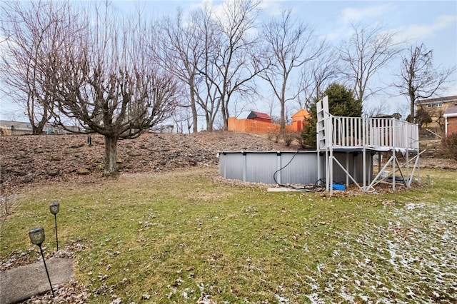 view of yard featuring an outdoor pool and a deck