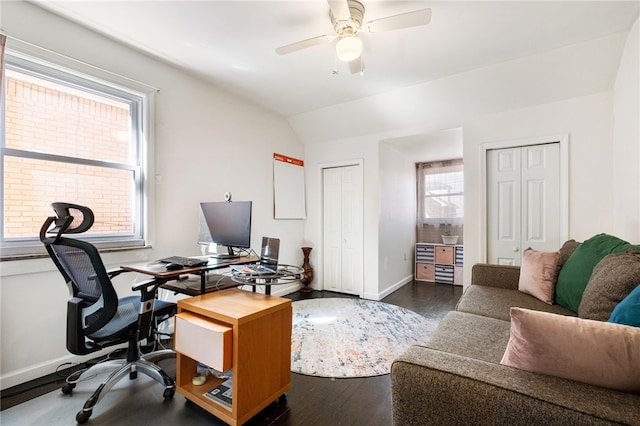 office featuring baseboards, dark wood-type flooring, a ceiling fan, and vaulted ceiling