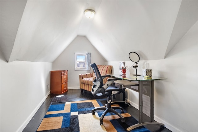 office space with baseboards, wood finished floors, and vaulted ceiling