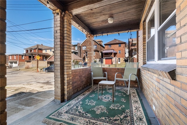 view of patio with a residential view and a balcony