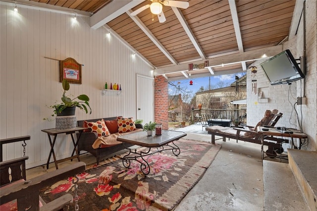 living room featuring a ceiling fan and vaulted ceiling with beams