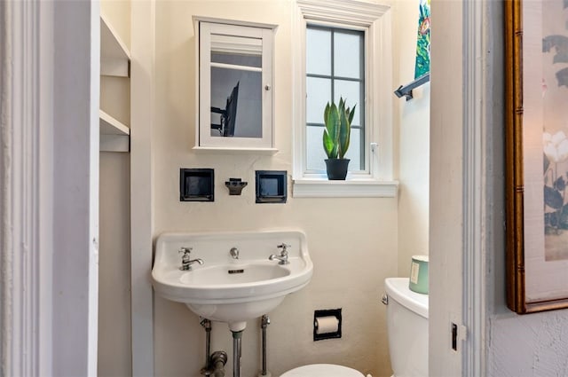 bathroom with toilet and a sink