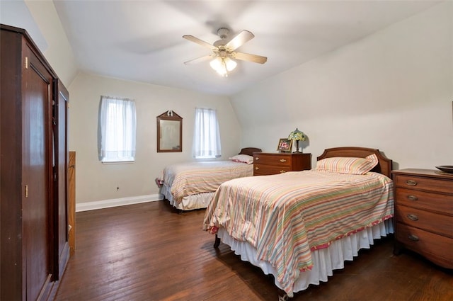 bedroom featuring vaulted ceiling, ceiling fan, baseboards, and dark wood-style flooring