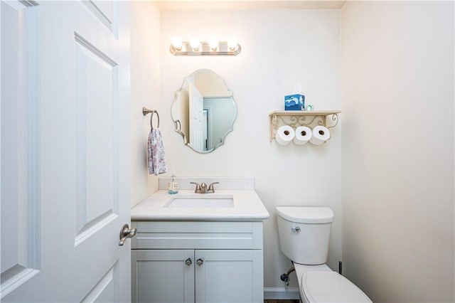 bathroom featuring toilet and vanity