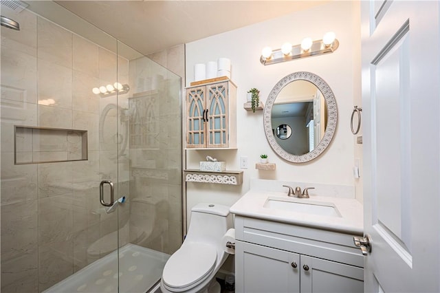 full bathroom featuring vanity, a shower stall, toilet, and visible vents