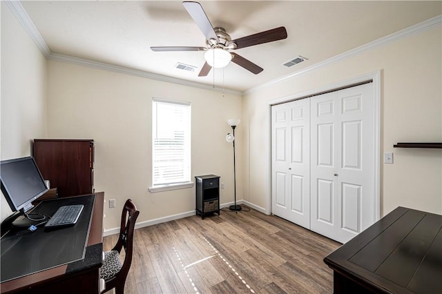 office space with baseboards, crown molding, a ceiling fan, and wood finished floors