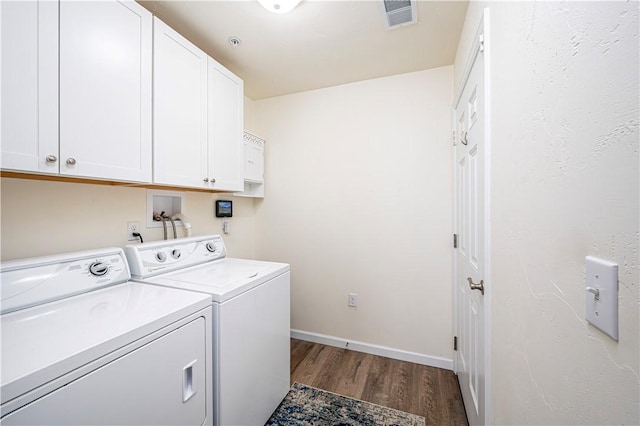 laundry room featuring visible vents, baseboards, washer and clothes dryer, dark wood-style floors, and cabinet space