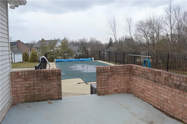 view of pool with a patio area, fence, and a fenced in pool