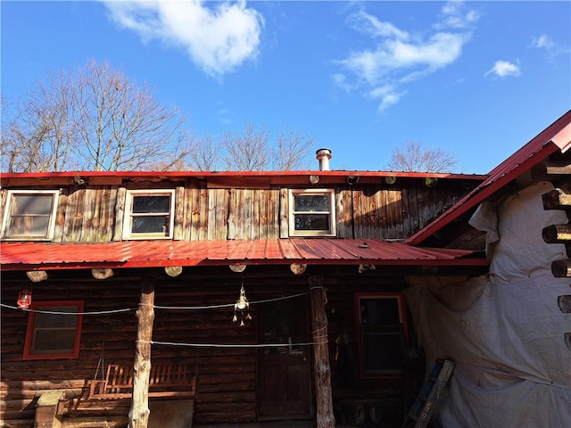 rear view of property featuring metal roof