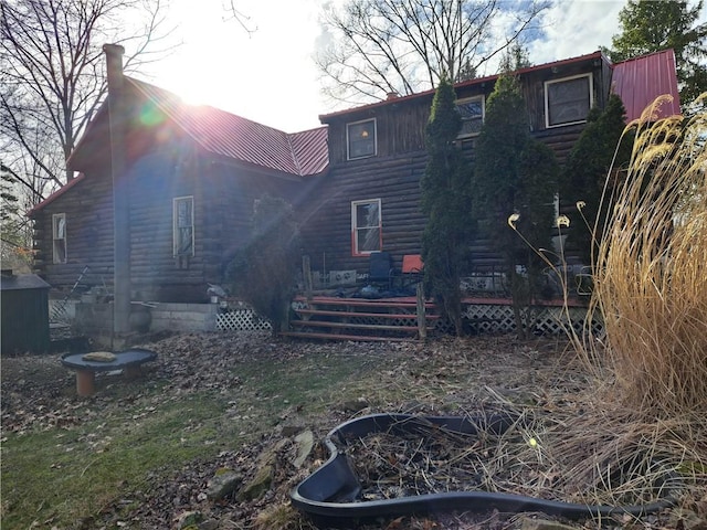 rear view of property featuring metal roof