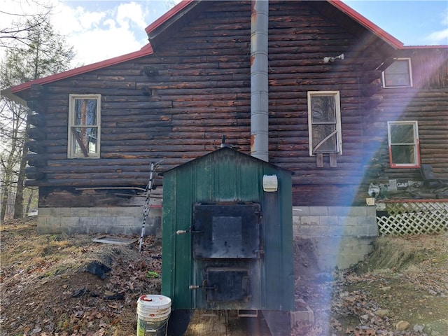 view of property exterior with log exterior