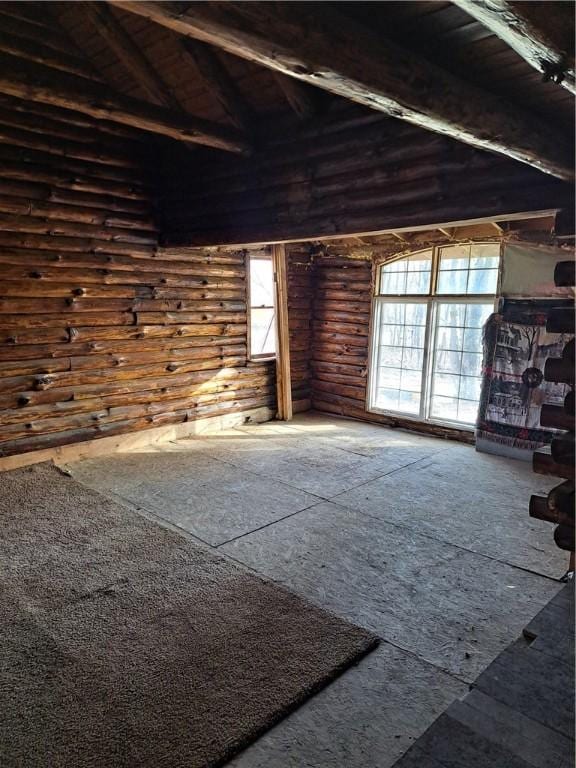 interior space featuring beamed ceiling, high vaulted ceiling, and log walls