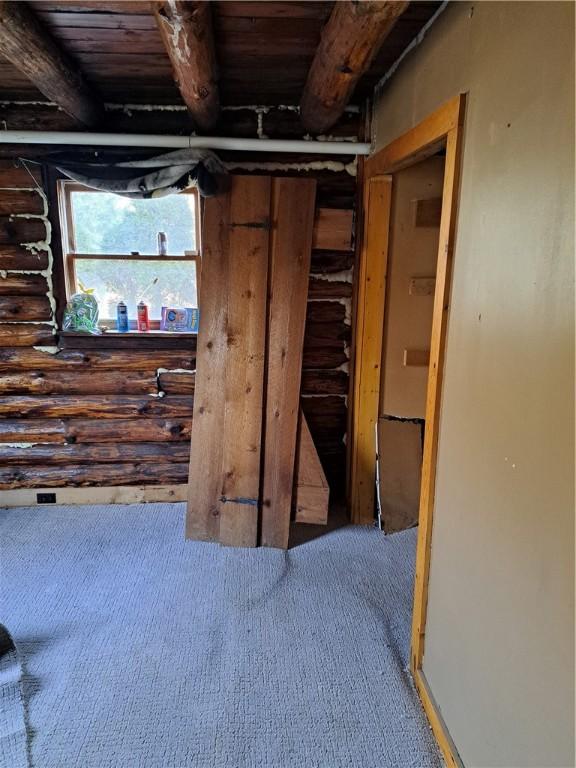 basement with carpet and wood ceiling