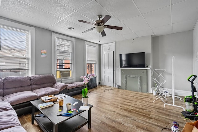 living area with visible vents, a paneled ceiling, ceiling fan, and wood finished floors