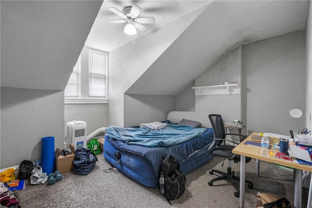 carpeted bedroom with a ceiling fan and vaulted ceiling