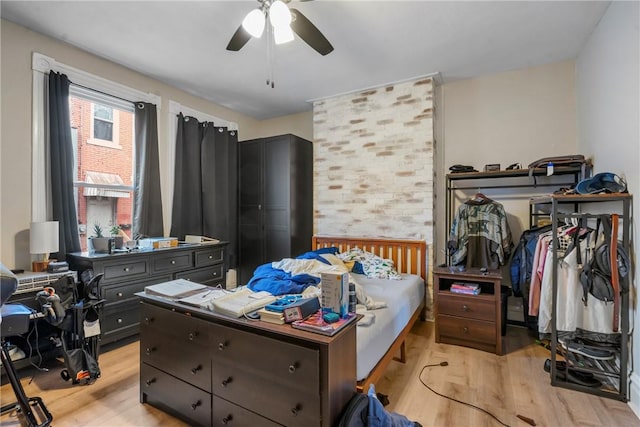 bedroom with light wood-style floors and a ceiling fan