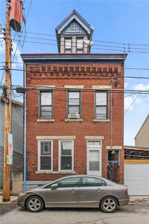 view of front of home featuring brick siding